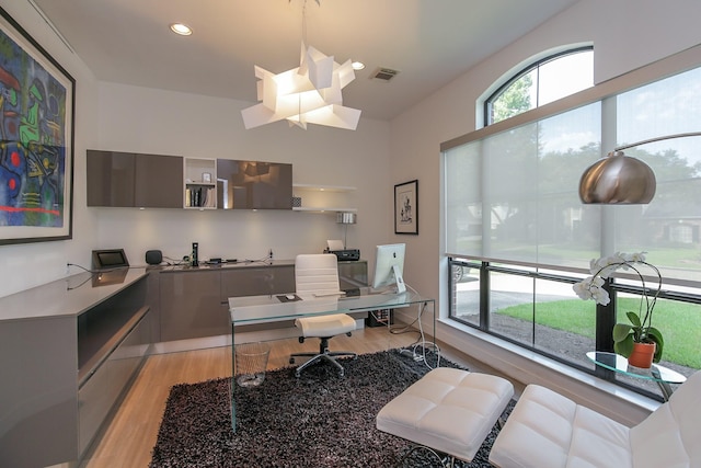 office featuring recessed lighting, light wood-style flooring, and visible vents
