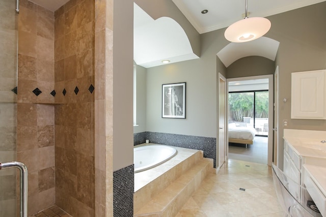 ensuite bathroom with crown molding, ensuite bath, tile patterned floors, a bath, and a stall shower