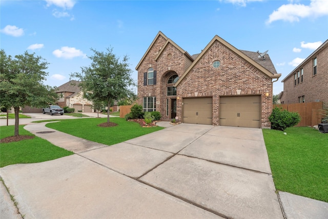 view of front of home featuring concrete driveway, brick siding, fence, and a front lawn