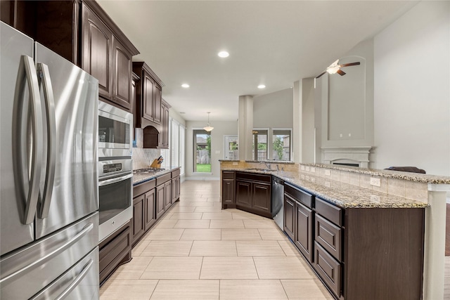 kitchen with recessed lighting, decorative backsplash, dark brown cabinetry, and stainless steel appliances
