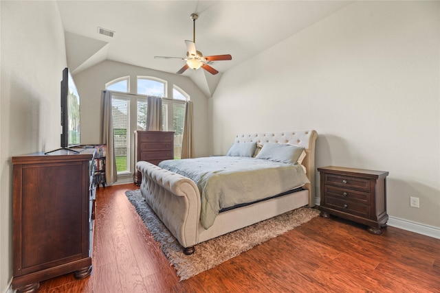 bedroom featuring ceiling fan, dark wood-style flooring, visible vents, baseboards, and lofted ceiling