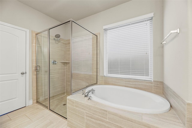 bathroom with a garden tub and a stall shower