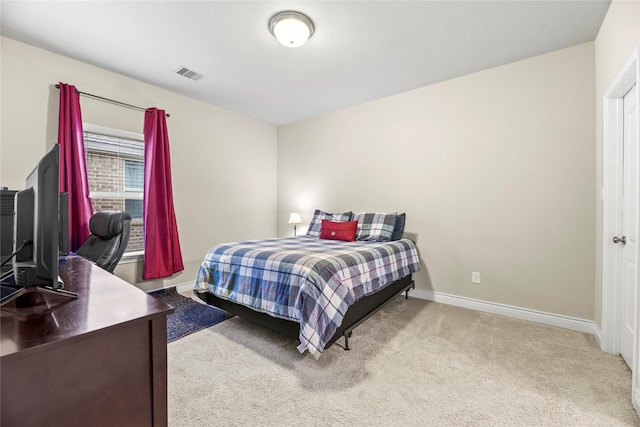 carpeted bedroom featuring visible vents and baseboards