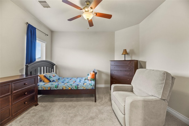 bedroom featuring baseboards, light colored carpet, and visible vents