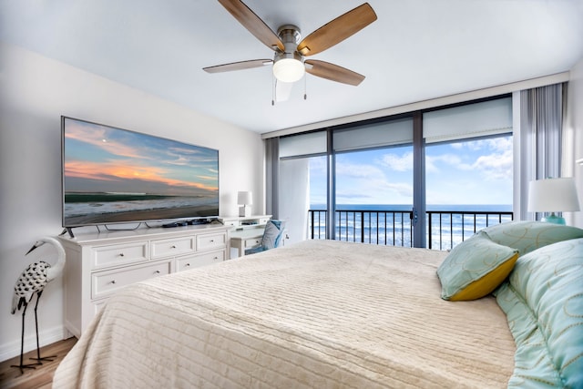 bedroom with ceiling fan, floor to ceiling windows, access to exterior, wood finished floors, and baseboards