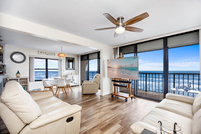 living room with a ceiling fan and wood finished floors