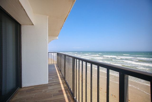 balcony with a beach view and a water view