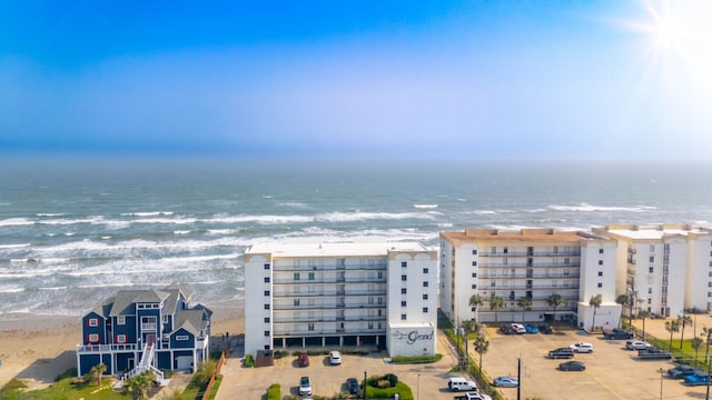 drone / aerial view featuring a water view and a view of the beach