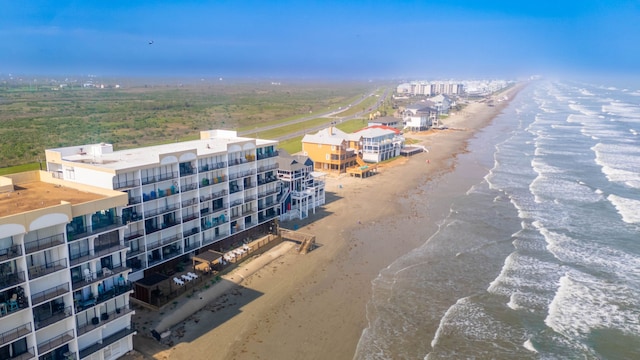 bird's eye view featuring a water view and a beach view