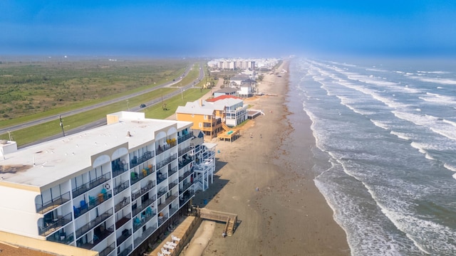 birds eye view of property with a beach view and a water view