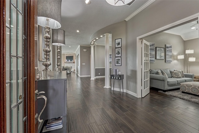 13625 Lakeside Place Dr, Willis, TX 77318 - foyer with ornamental molding, baseboards, ornate columns, and dark wood finished floors