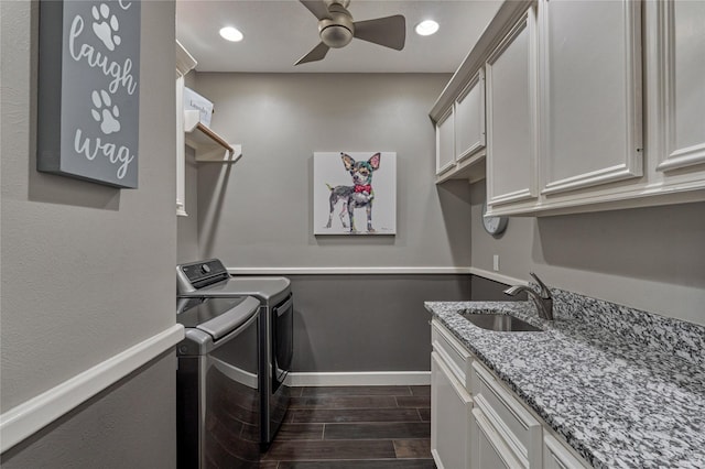 13625 Lakeside Place Dr, Willis, TX 77318 - laundry room featuring dark wood-style flooring, ceiling fan, a sink, washing machine and clothes dryer, and cabinet space