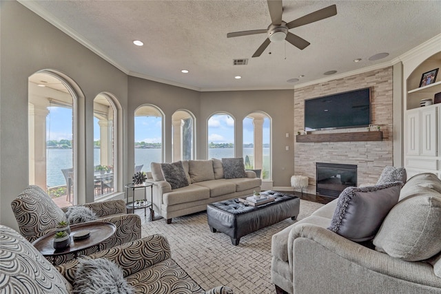 13625 Lakeside Place Dr, Willis, TX 77318 - living room with a wealth of natural light, ceiling fan, and a textured ceiling