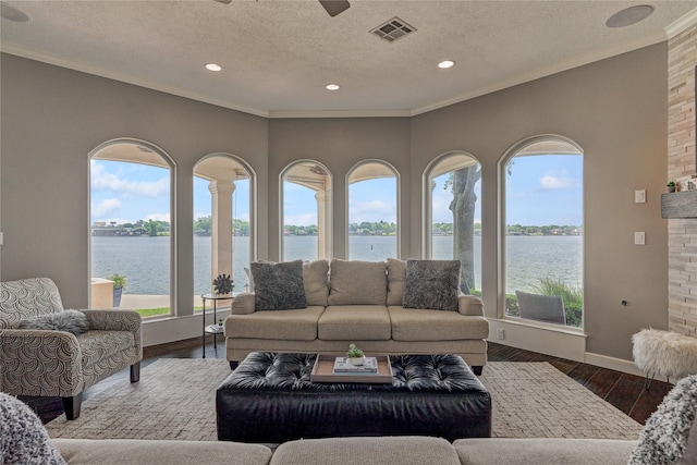 13625 Lakeside Place Dr, Willis, TX 77318 - living room featuring a water view, visible vents, and a textured ceiling