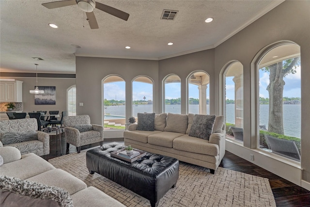 13625 Lakeside Place Dr, Willis, TX 77318 - living room with a water view, recessed lighting, ornamental molding, and visible vents