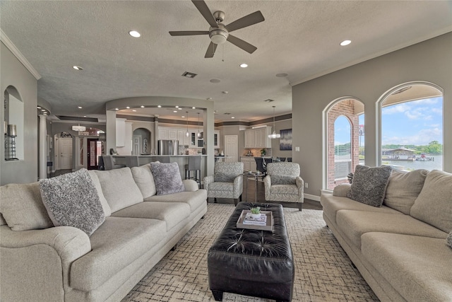 13625 Lakeside Place Dr, Willis, TX 77318 - living room featuring ornamental molding, a textured ceiling, ceiling fan, and recessed lighting