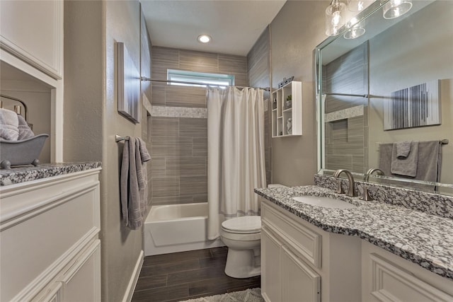 13625 Lakeside Place Dr, Willis, TX 77318 - full bathroom with toilet, wood finished floors, shower / bath combo with shower curtain, a textured wall, and vanity
