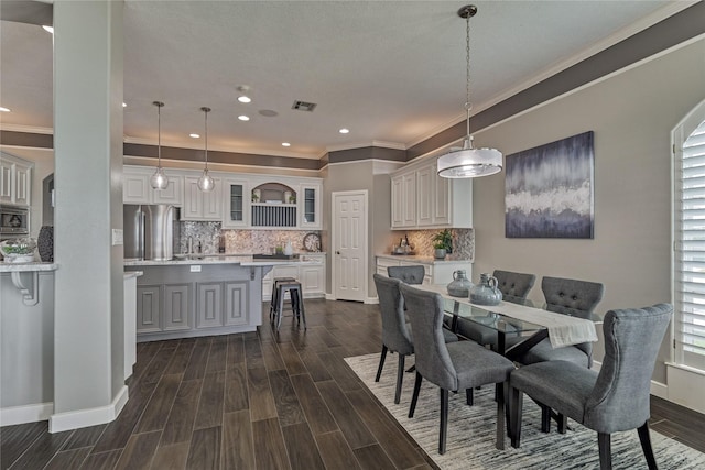 13625 Lakeside Place Dr, Willis, TX 77318 - dining area featuring visible vents, recessed lighting, dark wood finished floors, crown molding, and baseboards