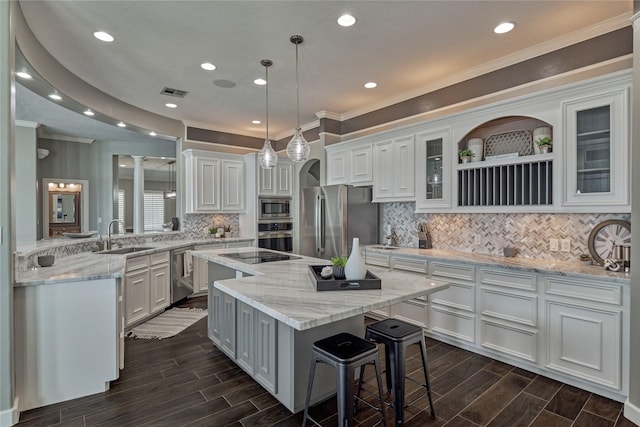 13625 Lakeside Place Dr, Willis, TX 77318 - kitchen with a sink, stainless steel appliances, crown molding, a center island, and white cabinets