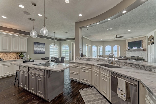 13625 Lakeside Place Dr, Willis, TX 77318 - kitchen with recessed lighting, dishwasher, a breakfast bar, a sink, and black electric cooktop