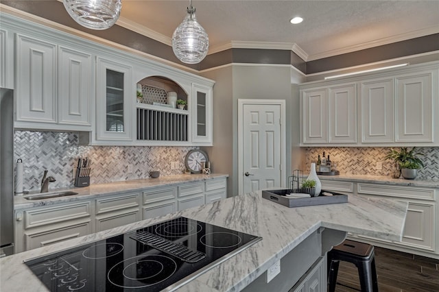 13625 Lakeside Place Dr, Willis, TX 77318 - kitchen with black electric stovetop, hanging light fixtures, white cabinets, and glass insert cabinets