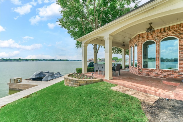 13625 Lakeside Place Dr, Willis, TX 77318 - view of yard featuring a dock, a patio, and a water view