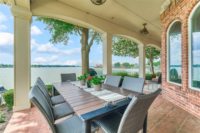 13625 Lakeside Place Dr, Willis, TX 77318 - view of patio featuring outdoor dining area and a water view
