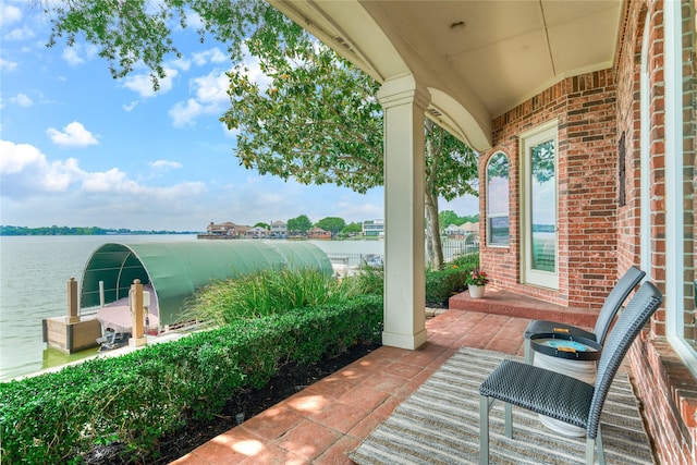 13625 Lakeside Place Dr, Willis, TX 77318 - view of patio / terrace with a water view