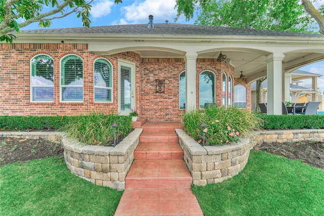 13625 Lakeside Place Dr, Willis, TX 77318 - entrance to property featuring a porch, brick siding, and a shingled roof