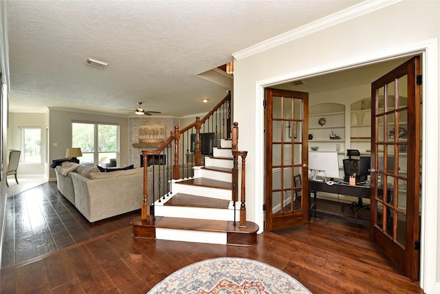 living area with french doors, a ceiling fan, visible vents, hardwood / wood-style flooring, and ornamental molding