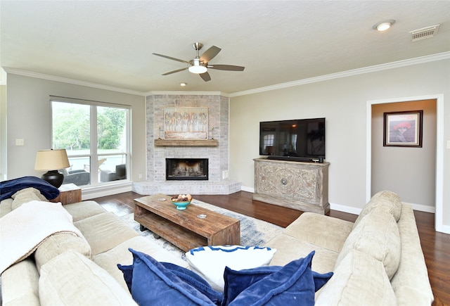 living room with visible vents, a ceiling fan, wood finished floors, and ornamental molding