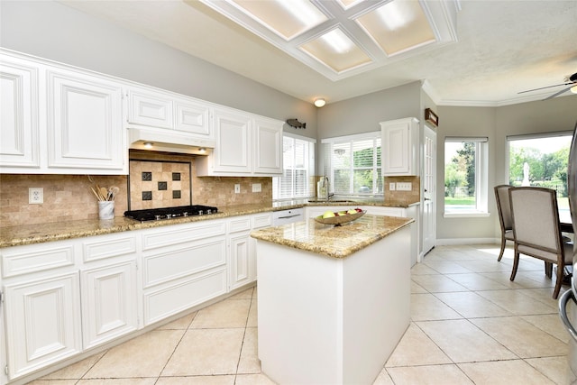 kitchen featuring stainless steel gas stovetop, light tile patterned floors, tasteful backsplash, and a ceiling fan