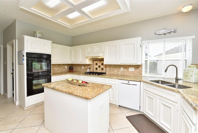 kitchen featuring dobule oven black, dishwasher, a center island, a sink, and light tile patterned floors