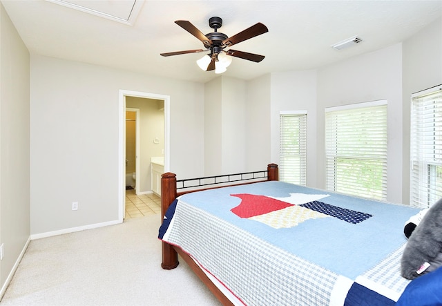 bedroom featuring a ceiling fan, visible vents, baseboards, ensuite bathroom, and carpet flooring