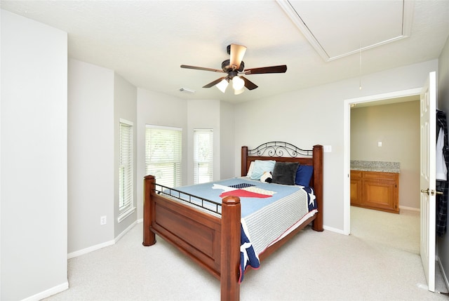 bedroom featuring visible vents, attic access, baseboards, and light carpet