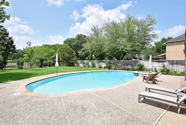 view of swimming pool featuring a lawn, a fenced backyard, a pool with connected hot tub, and a patio