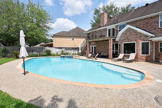 view of pool with a fenced backyard, a patio area, and a pool with connected hot tub