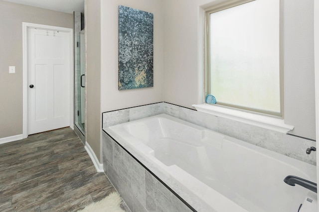 3300 Michelle Ave, Vidor, TX 77662 - bathroom featuring a garden tub, a stall shower, baseboards, and wood finished floors
