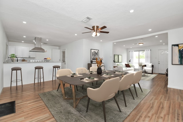dining room with recessed lighting, a ceiling fan, and light wood-style flooring