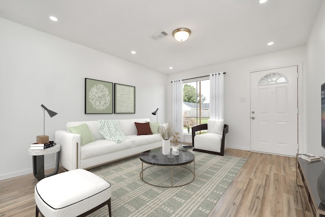 living area featuring visible vents, recessed lighting, light wood finished floors, and baseboards