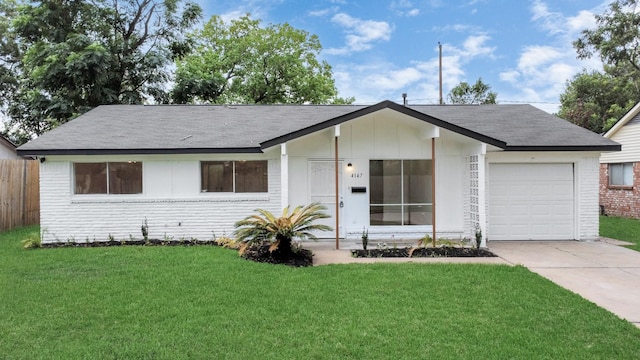 ranch-style home with fence, a front lawn, brick siding, a garage, and driveway