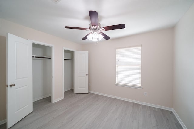 unfurnished bedroom featuring baseboards, a ceiling fan, and light wood-style flooring