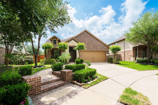 view of front facade with a garage, fence, concrete driveway, and brick siding
