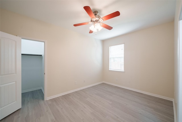 unfurnished room featuring ceiling fan, baseboards, and light wood finished floors