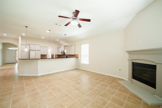 unfurnished living room with visible vents, lofted ceiling, recessed lighting, arched walkways, and a ceiling fan