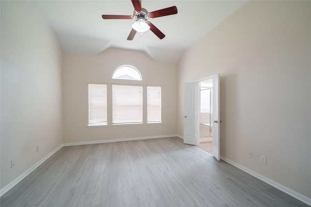 unfurnished room featuring baseboards, ceiling fan, wood finished floors, and lofted ceiling