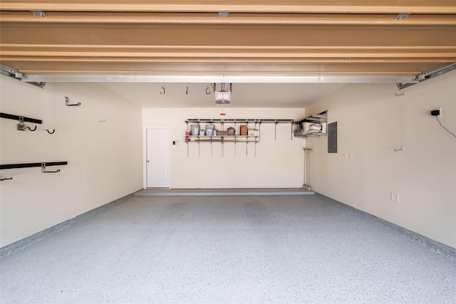 garage featuring a garage door opener and electric panel