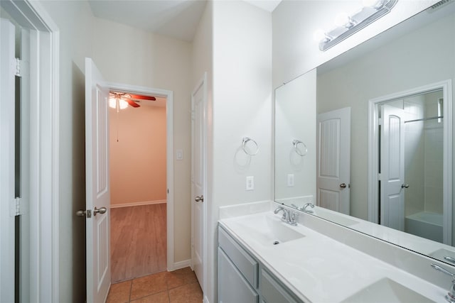 bathroom featuring double vanity, a ceiling fan, a sink, and tile patterned flooring