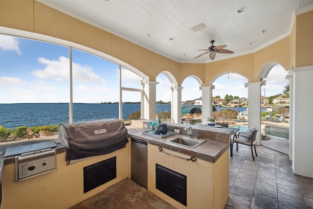view of patio featuring ceiling fan, grilling area, area for grilling, a water view, and a sink