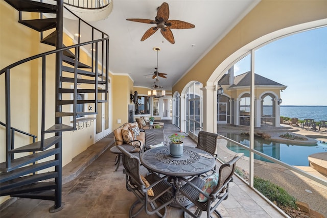 view of patio with ceiling fan, french doors, an outdoor pool, stairway, and a water view